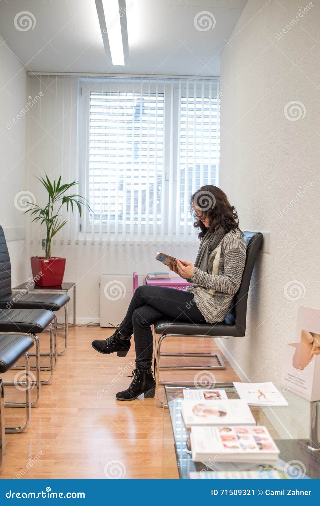 patient reading a magazine in the doctorÃ¢â¬â¢s waiting room